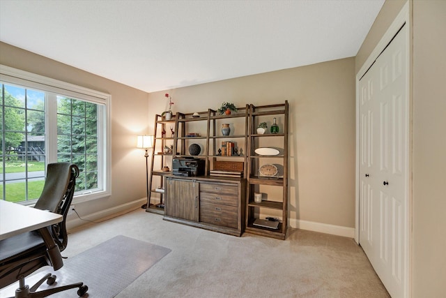 home office featuring light carpet and baseboards
