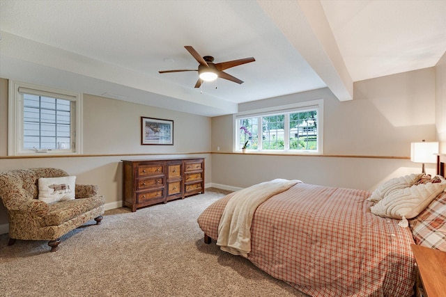 bedroom featuring carpet floors, baseboards, a ceiling fan, and beamed ceiling