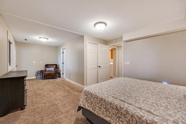 carpeted bedroom with baseboards and a textured ceiling