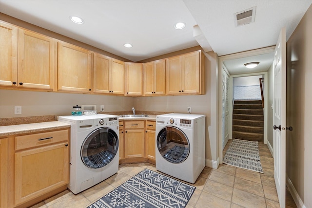 clothes washing area featuring cabinet space, recessed lighting, washing machine and dryer, baseboards, and light tile patterned floors