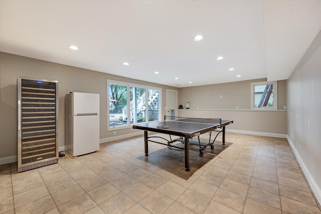 playroom featuring a heating unit, healthy amount of natural light, light tile patterned flooring, recessed lighting, and baseboards