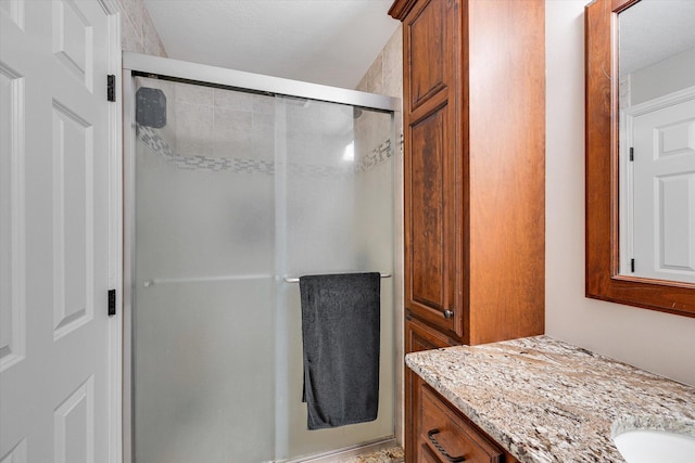 full bath with a shower stall and vanity