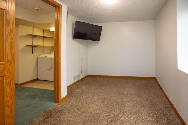 interior space with visible vents, baseboards, washer / clothes dryer, carpet, and a textured ceiling