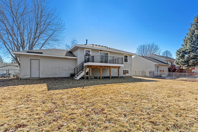 back of property with a fenced backyard, stairs, a lawn, and a wooden deck