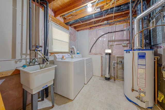 clothes washing area with gas water heater, independent washer and dryer, and laundry area