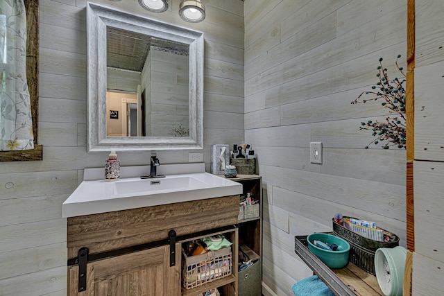 bathroom featuring wood walls and vanity