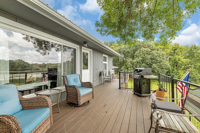 deck with a grill and a water view