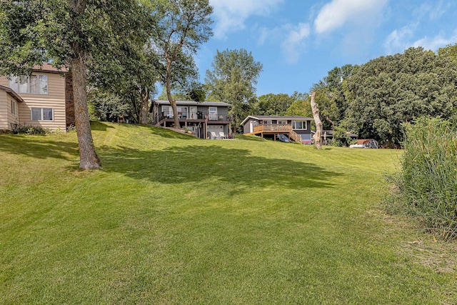 view of yard with a deck and stairs