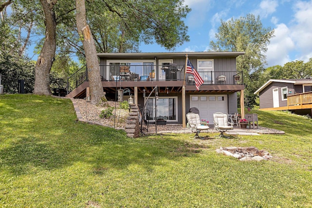 rear view of house with stairway, a wooden deck, a lawn, a patio area, and an attached garage