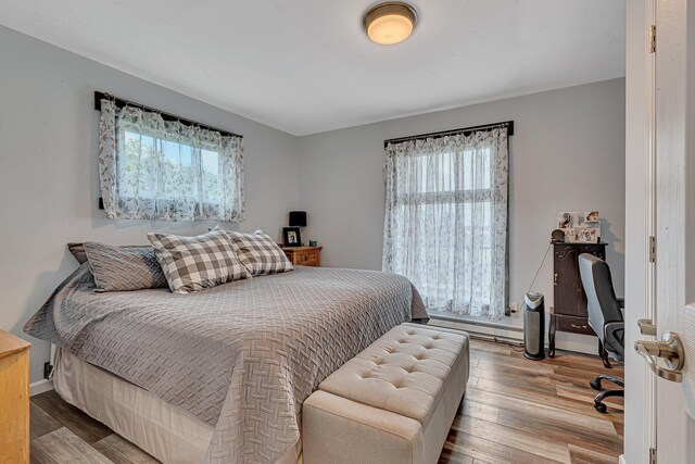 bedroom featuring baseboards and wood finished floors