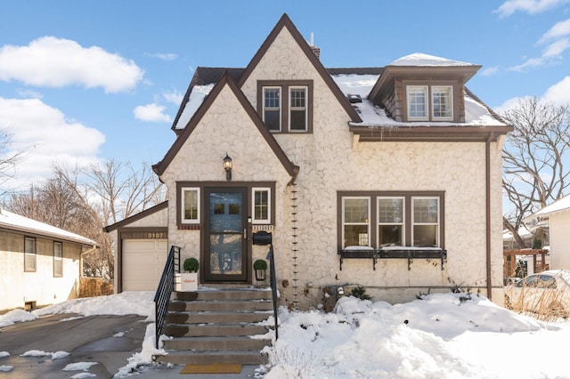 view of front of property featuring stone siding and an attached garage