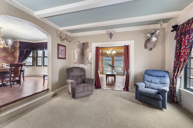 sitting room with arched walkways, beamed ceiling, carpet flooring, and a notable chandelier