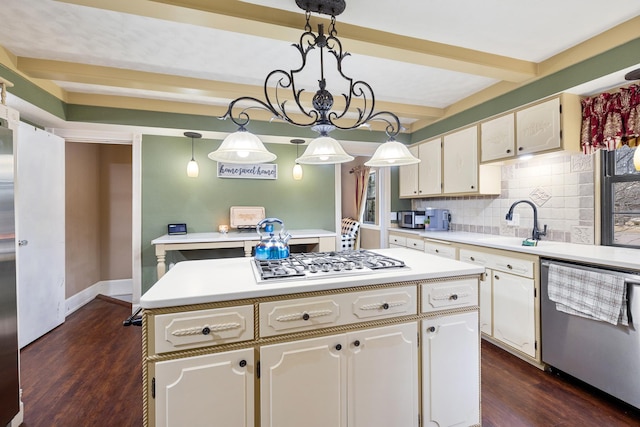 kitchen featuring appliances with stainless steel finishes, beam ceiling, light countertops, and tasteful backsplash