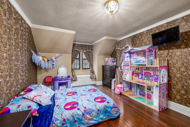 bedroom with wallpapered walls, a textured ceiling, ornamental molding, and wood finished floors