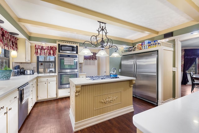 kitchen with dark wood finished floors, stainless steel appliances, light countertops, and beamed ceiling