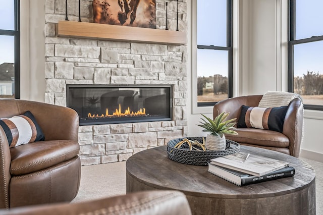 living area featuring a stone fireplace