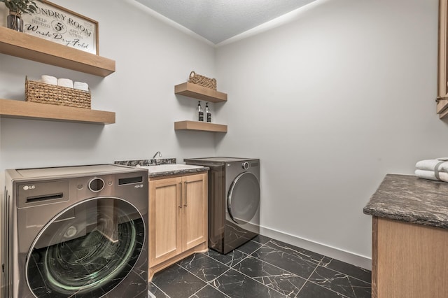 laundry room with cabinet space, baseboards, marble finish floor, a textured ceiling, and separate washer and dryer