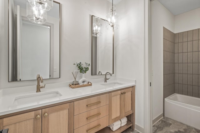 full bathroom with double vanity, tub / shower combination, a sink, and baseboards