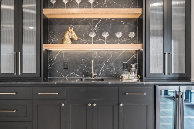 bar featuring a sink, wine cooler, indoor wet bar, and backsplash