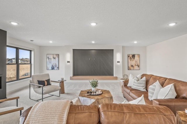 living room with a textured ceiling, carpet, baseboards, and recessed lighting