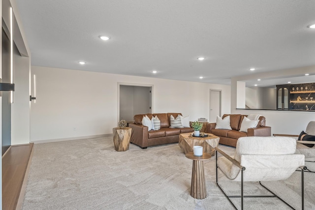 living room with baseboards, a textured ceiling, carpet flooring, and recessed lighting