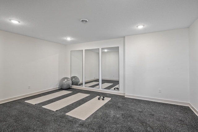 workout room with a textured ceiling, recessed lighting, and baseboards