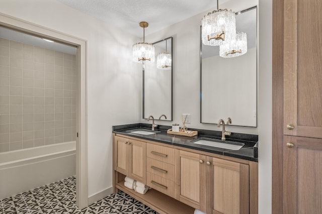 full bath with tile patterned floors, a sink, baseboards, and double vanity