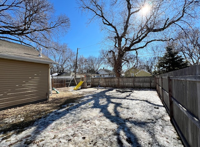 view of yard with a playground and a fenced backyard