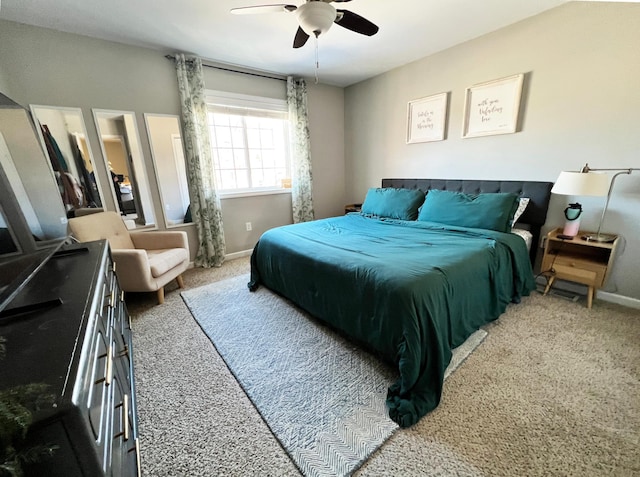 carpeted bedroom featuring ceiling fan and baseboards