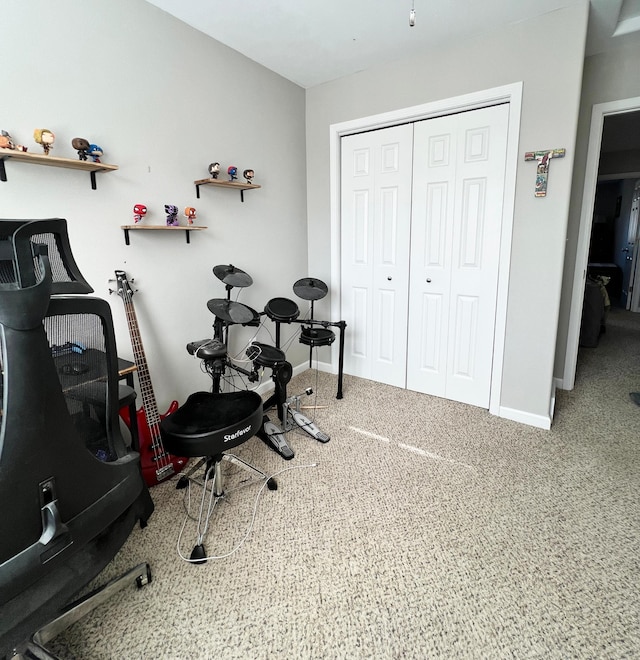 workout area with carpet and baseboards