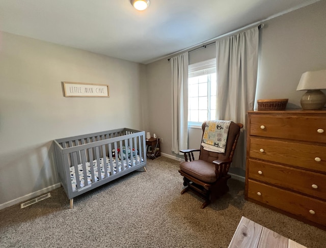 carpeted bedroom featuring a nursery area, visible vents, and baseboards