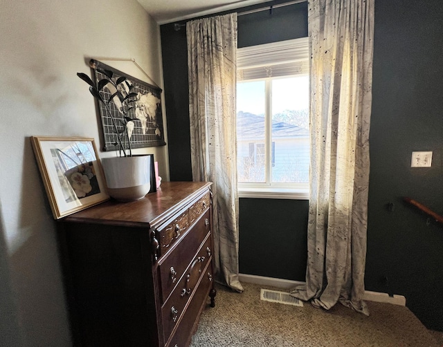 interior space featuring baseboards and visible vents