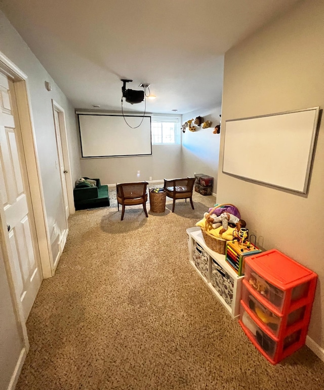 carpeted cinema room featuring baseboards