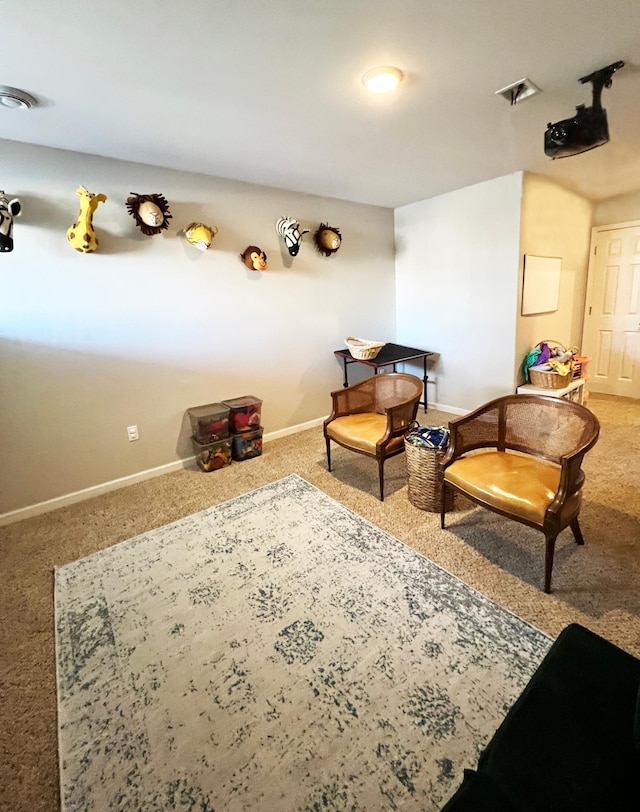 sitting room featuring visible vents, baseboards, and carpet flooring