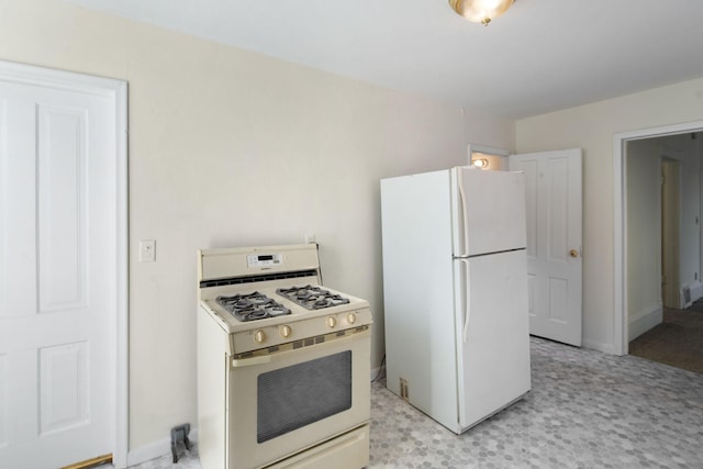 kitchen featuring white appliances and baseboards