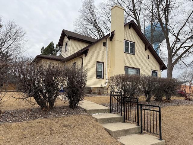 view of side of home featuring a chimney