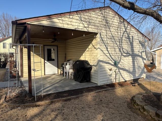 rear view of house featuring a ceiling fan and a patio