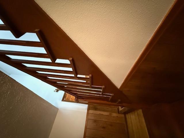 staircase with lofted ceiling