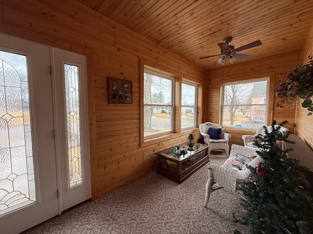 interior space with lofted ceiling, wooden ceiling, and a ceiling fan