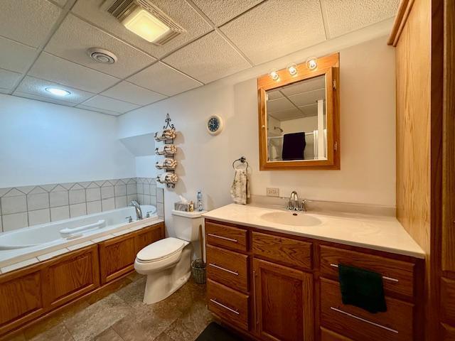 full bath featuring visible vents, vanity, toilet, and a bath