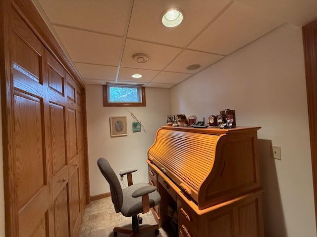 home office featuring a paneled ceiling and baseboards