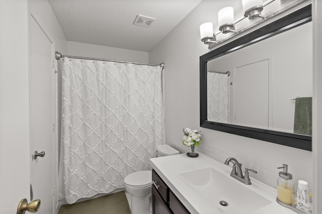 bathroom with visible vents, toilet, curtained shower, a textured ceiling, and vanity