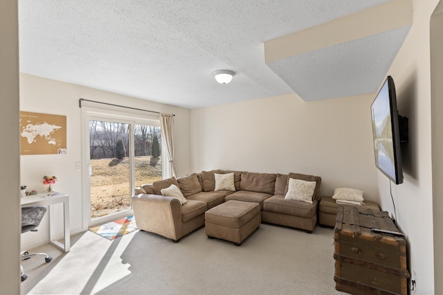 living area with light carpet and a textured ceiling