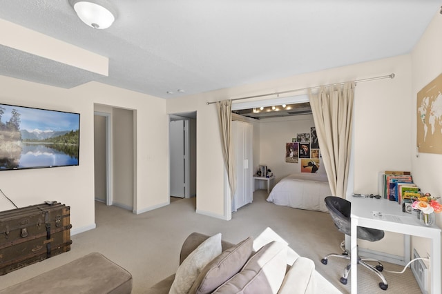 bedroom with light carpet and baseboards