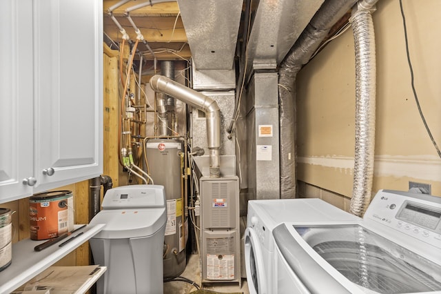 laundry room with gas water heater, cabinet space, and washer and dryer