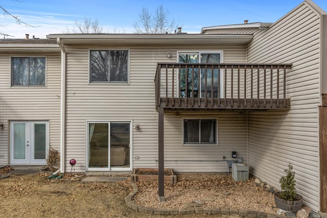 rear view of property featuring a deck and french doors