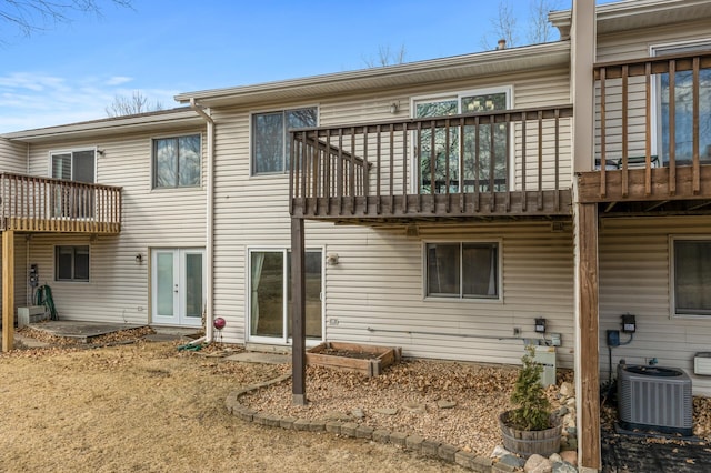 rear view of property featuring french doors and central air condition unit