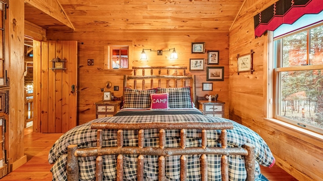 bedroom featuring wooden ceiling, wood finished floors, and wood walls