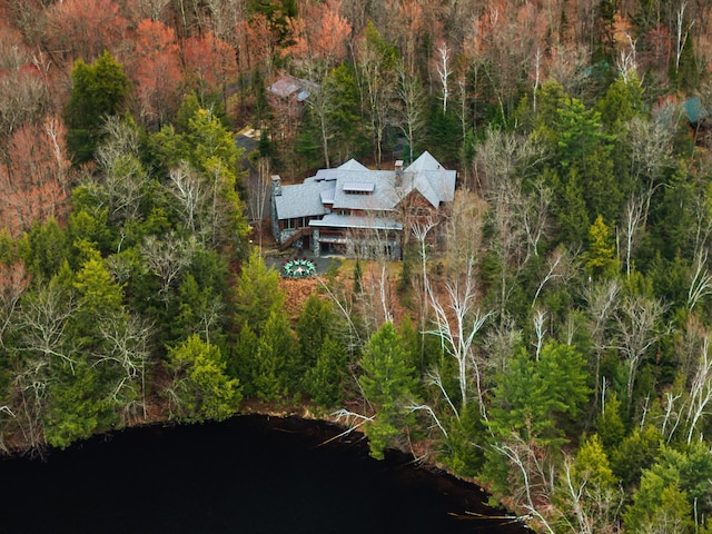 view from above of property with a forest and a large body of water