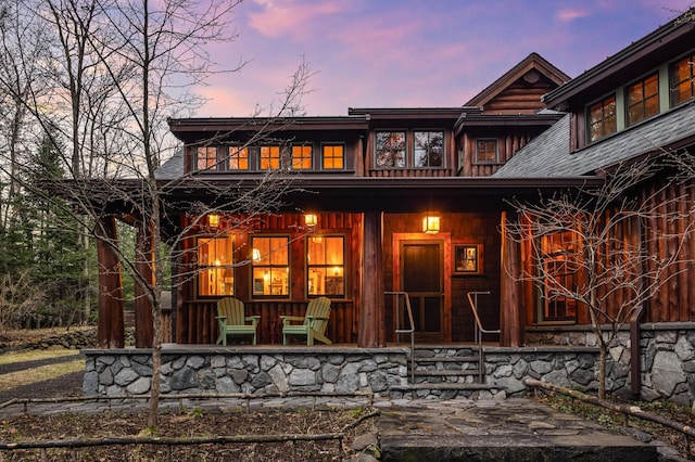 rear view of property with covered porch